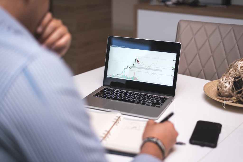 Gentleman ßitting at his desk study graph charts 